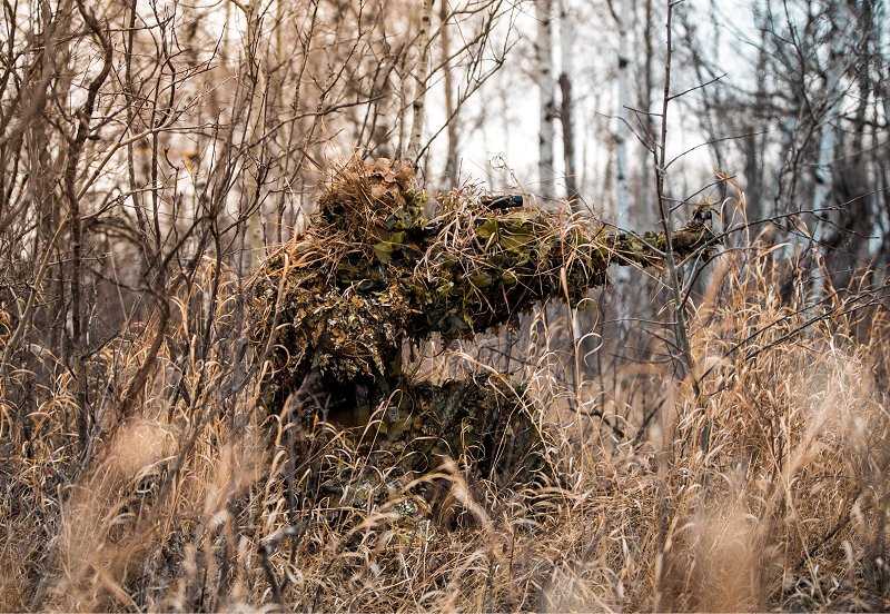 soldier wearing a ghillie suit